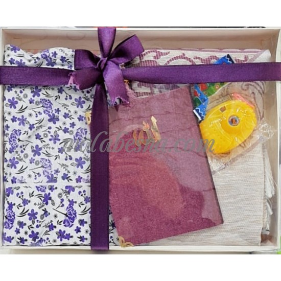 Box containing kids praying clothes Holy Quraan Rosary and a toy