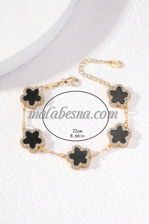 Golden bracelet with black flower and diamonds