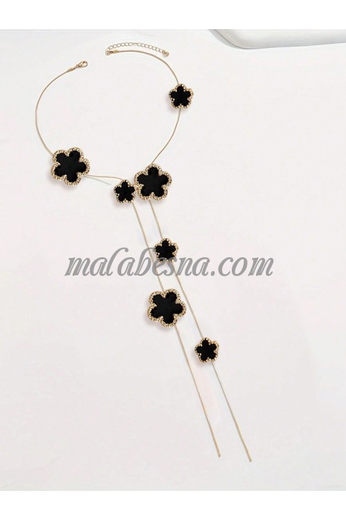 Long golden necklace with black flower shape
